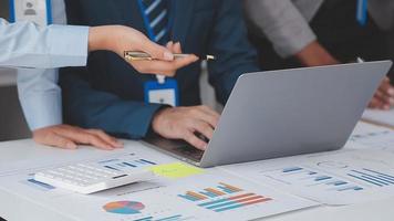 Financial analysts analyze business financial reports on a digital tablet planning investment project during a discussion at a meeting of corporate showing the results of their successful teamwork. video