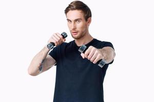 man with dumbbells in his hands Sport Fitness tattoo on his arm and white background photo