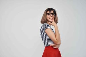 woman in striped t-shirt sunglasses studio isolated background photo