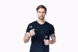 a man in a black T-shirt with dumbbells in his hands Sport Fitness Model photo