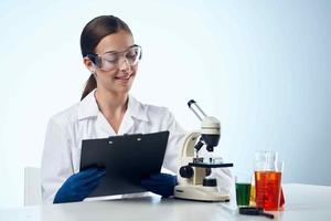 woman doctor medicine research microscope photo