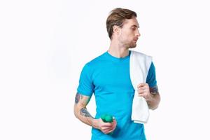 man with dumbbells in hands towel on shoulder workout fitness light background photo