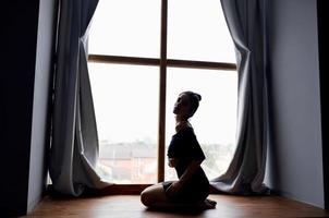 silhouette of woman posing near window model photo