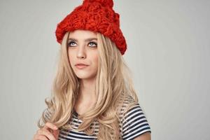 pretty woman in a striped T-shirt Red Hat posing Studio photo