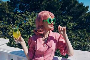 cheerful woman with pink hair summer cocktail refreshing drink Summer day photo