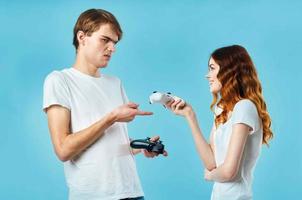 young couple in white t-shirts with joysticks in hands playing entertainment photo
