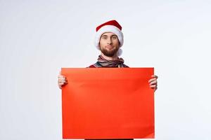 emotional man in a christmas hat with Red mockup poster light background photo