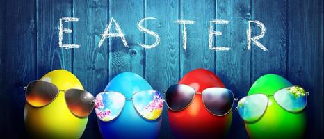 Easter background with colorful easter eggs on wooden background. photo