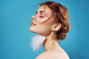 woman with bare shoulders fluffy mesh blue background photo