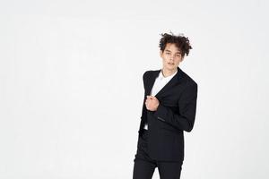 handsome guy with curly hair and in a jacket shirt pants model photo