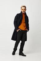 man in fashionable clothes pants coat style hands in pockets photo