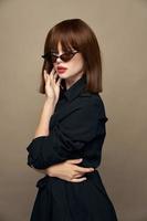 Charming brunette dark glasses isolated background Copy spaces photo