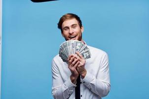 Cheerful man with bundles of money wealth emotion joy photo