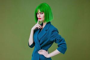 Beautiful fashionable girl fun gesture hands green hair fashion studio model unaltered photo