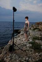 short haired woman in dress on nature rocks landscape outdoors photo