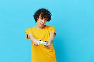 guy plays with joystick in yellow t-shirts Lifestyle entertainment photo