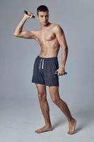 sports man with dumbbells in his hands in shorts motivation exercise photo