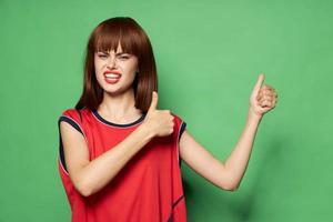 A woman in a soccer jersey shows a thumb photo