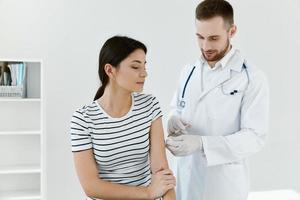 doctor injections into patient's arm health treatment covid vaccination photo