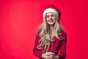 merry woman santa hats christmas holiday fashion red background photo