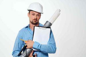 engineer in a construction helmet drawings documents construction photo