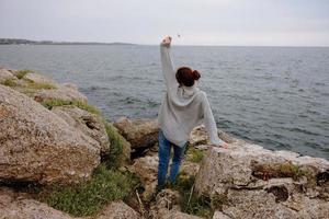 beautiful woman beach tourism cloudy weather stone coast Relaxation concept photo