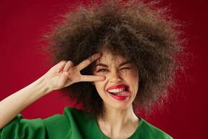 Young woman grimace afro hairstyle red lips fashion red background unaltered photo