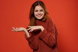 cheerful woman in red sweater posing fashion decoration photo