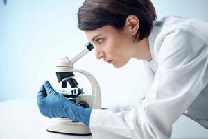 female doctor laboratory science research microscope photo