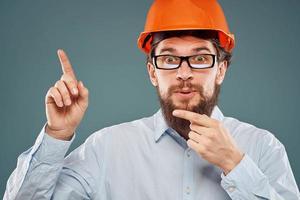 Business man in orange paint construction emotions gesturing with hands Professional cropped view photo