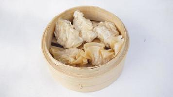 steamed dumpling dim sum in bamboo basket on white background photo