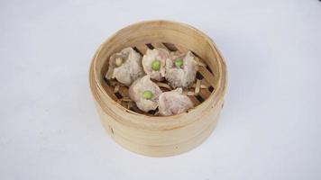 steamed beef meat dimsum in bamboo basket on white background photo