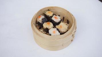 steamed dumpling dim sum in bamboo basket on white background photo