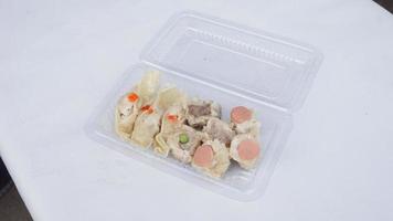 steamed dimsum with sausage and shrimp in plastic box photo