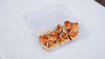 spicy dimsum in plastic box on white background, asian food photo