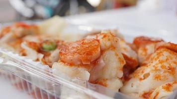 Close up of fried dumplings in a plastic box on the table photo