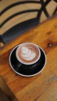 Coffee cup on wooden table in coffee shop, stock photo