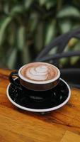 Top view offee cup on wooden table in coffee shop, stock photo