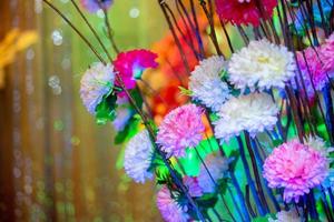 Hand made paper flower stick and colorful lighting. photo