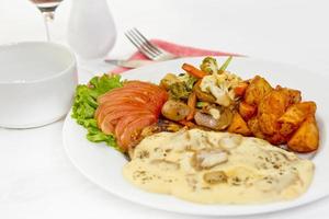 Peri peri Chicken with Button mushroom gravy, Saute Vegetables, Spicy fried Potatoes with Tomato Lettuce Salad. photo