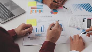 Financial analysts analyze business financial reports on a digital tablet planning investment project during a discussion at a meeting of corporate showing the results of their successful teamwork. video