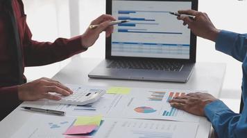 Financial analysts analyze business financial reports on a digital tablet planning investment project during a discussion at a meeting of corporate showing the results of their successful teamwork. video