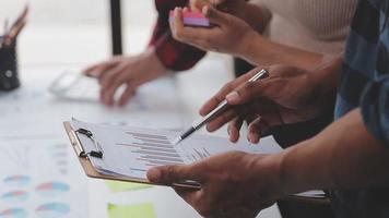 Financial analysts analyze business financial reports on a digital tablet planning investment project during a discussion at a meeting of corporate showing the results of their successful teamwork. video
