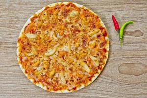 Classic Seafood Pizza with spicy chilli sauce. photo