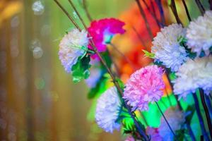 Hand made paper flower stick and colorful lighting. photo