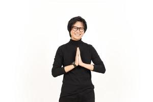 Smiling and doing namaste greeting Of Handsome Asian Man Isolated On White Background photo