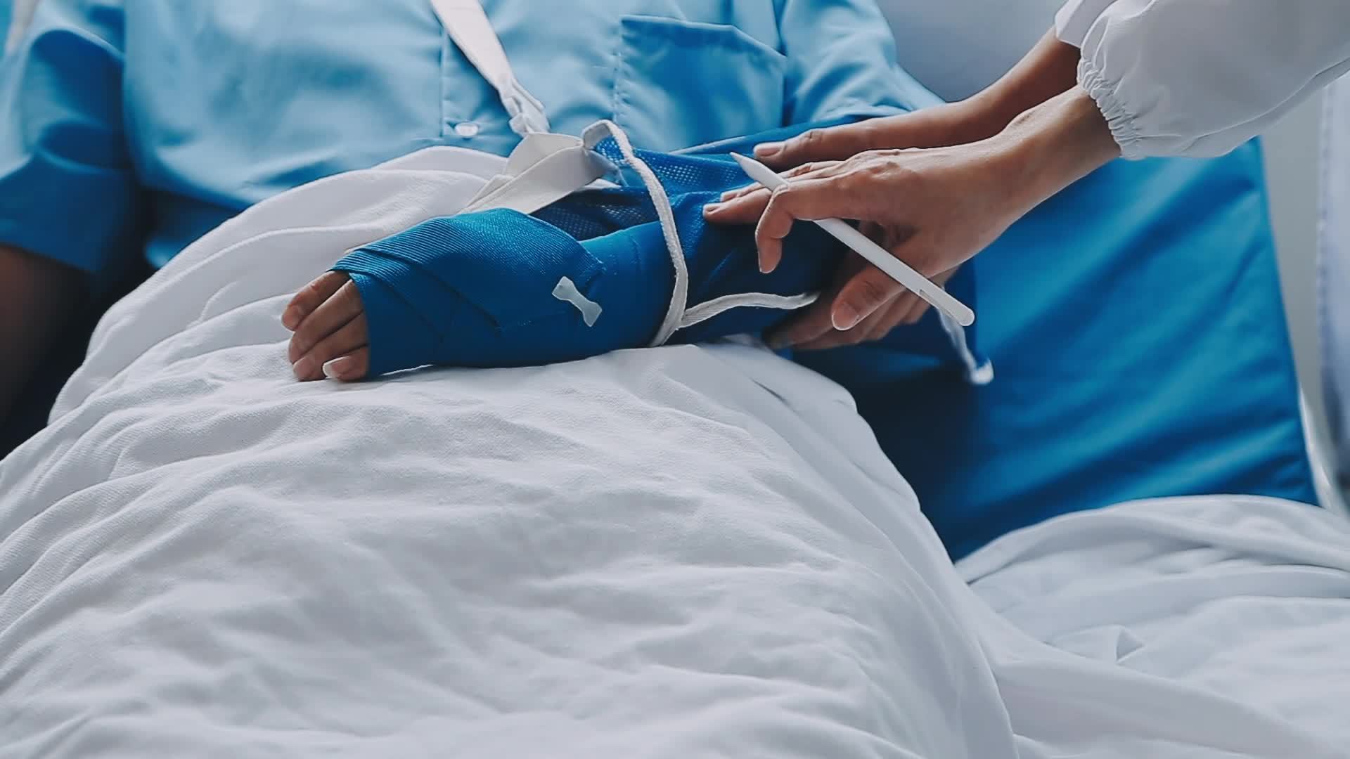 Man with broken arm in cast lying on bed in hospital. The emergency