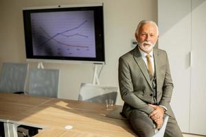 Senior business man in the boardroom at the office photo