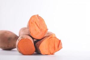 Close up of sweet potatoes on white background with copy space. Healthy vegan vegetarian food concept photo