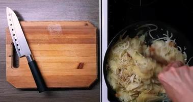 Frying potatoes and onions in a deep pan, top view. video